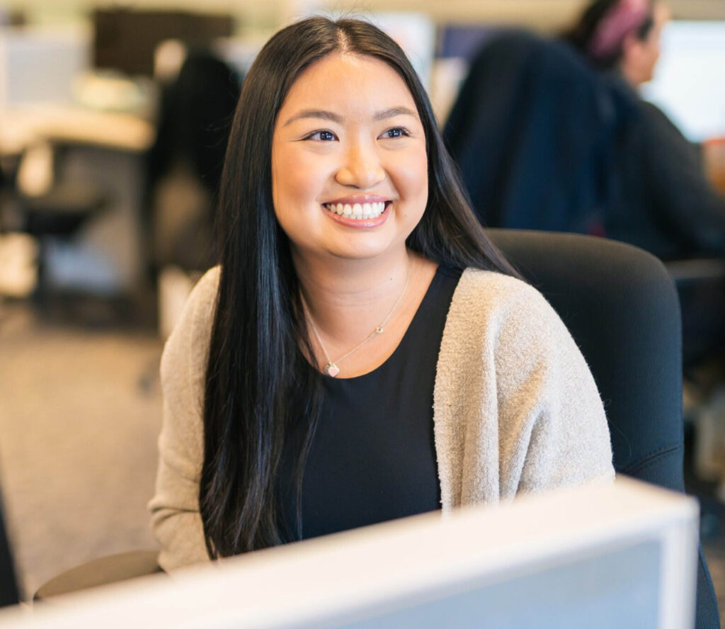Administrative assistant smiling at desk