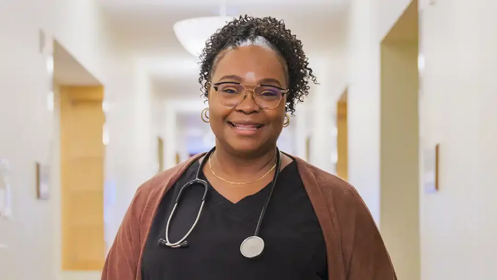 Nurse with stethoscope smiling